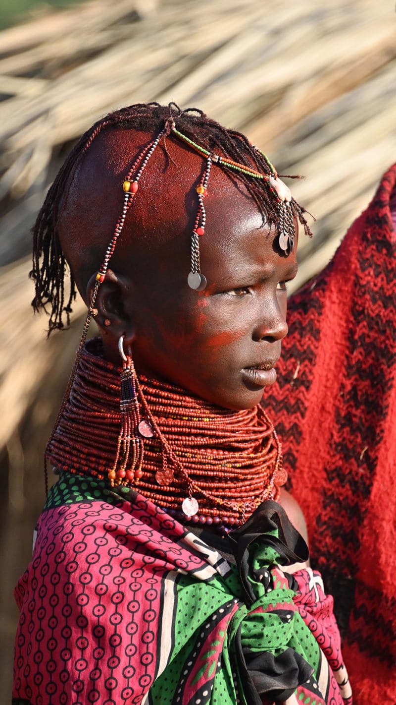 Maasai woman adorned with red ochre and beaded jewelry